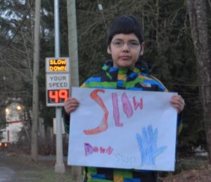 Daniel Page got fed up with cars and trucks speeding on Chemainus Road through Halalt First Nation so he made a sign that he shows to passing motorists.