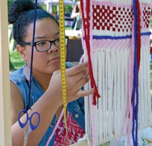 woman weaving on a loom