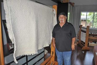 man in front of woven blanket