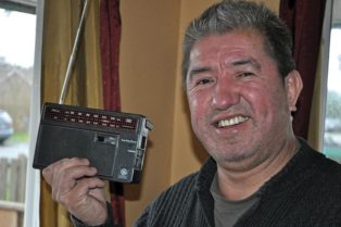 man holding up portable radio