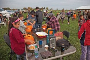 People cleaning pumpkins on a farm