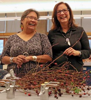 two women with dried plants