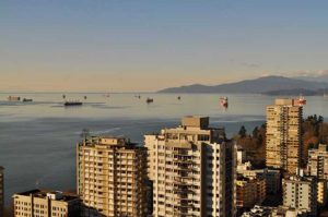 oil tankers off the shores of a cityscape