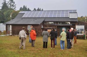 people looking at solar panels on building