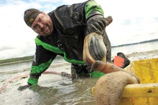 man holding geoduck