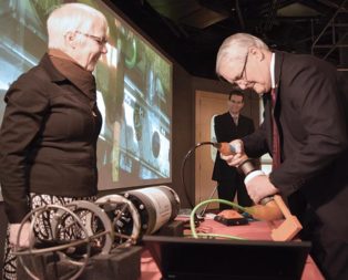 man testing equipment while woman watches