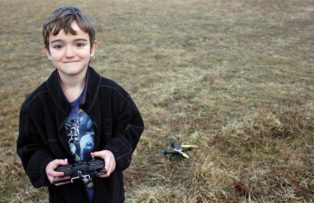 child with drone helicopter