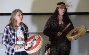 First Nations women drumming and singing