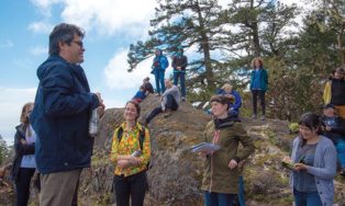 Chief talking to students in the forest