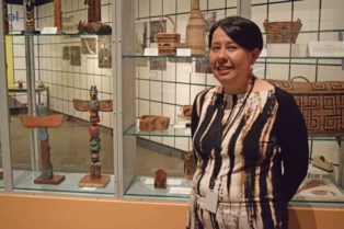 women in front of indegenous art exhibit