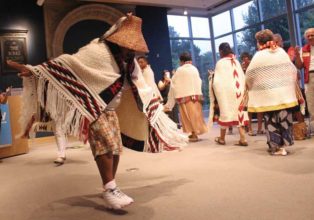 dancers wearing woven blankets