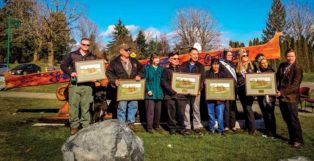 group standing in front of salish canoe