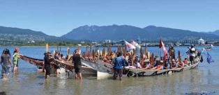 canoes arrive after Pulling Together Canoe Journey